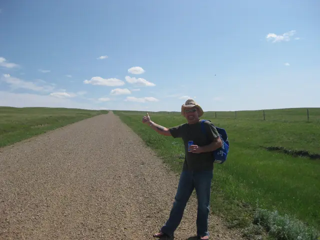 Hitchhiking on a gravel road through prairie